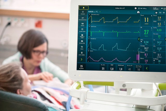Servo-n screen in focus front view in clinical environment with a neonate patient with nava on pc screen