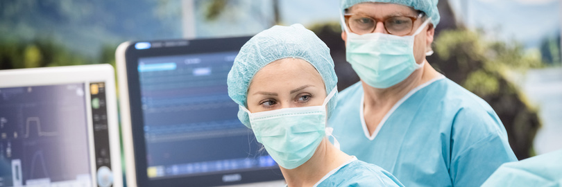 Nurses monitoring patient in hybrid OR