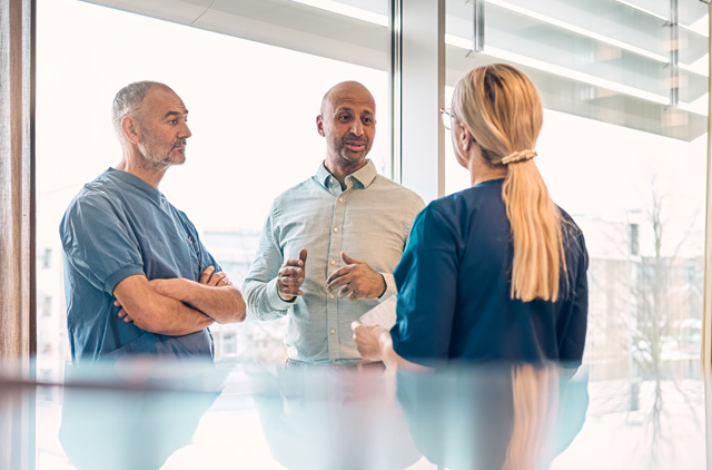 Three people meeting in a conference room