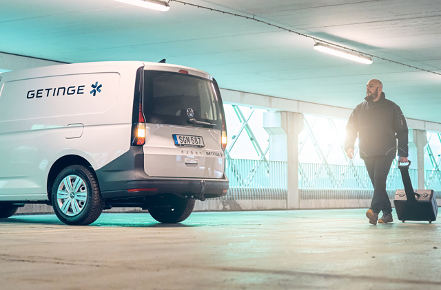 Getinge service car and technician in parking garage