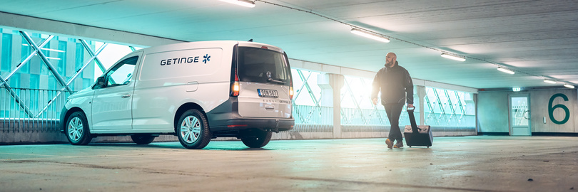 Getinge service car and technician in parking garage