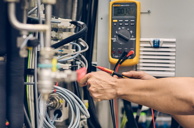 Female technician working on a machine